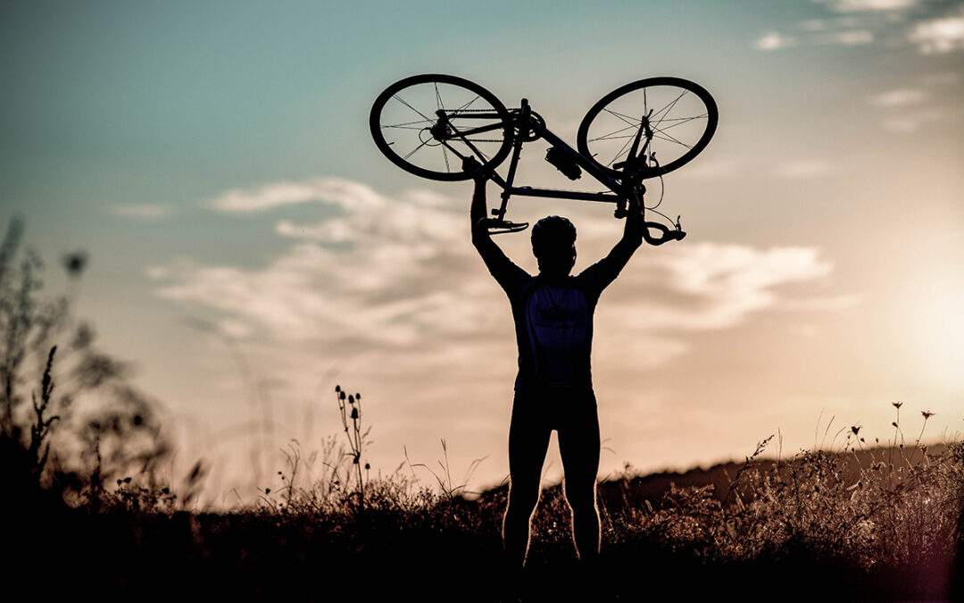 cyclist-silhoutte-with-bicycle-raised-to-sky-race-2022-08-18-06-47-56-utc-1080x675.jpg